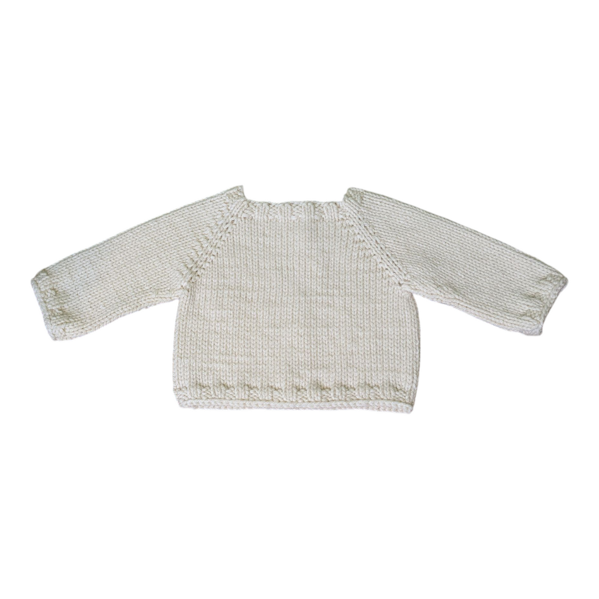 A cream-colored, hand-knit long-sleeve sweater with ribbed hem, displayed flat against a plain white background.