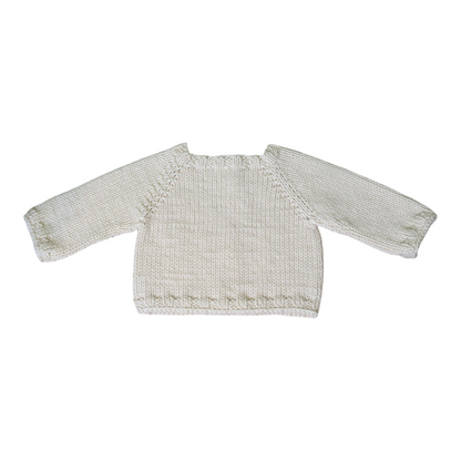 A cream-colored, hand-knit long-sleeve sweater with ribbed hem, displayed flat against a plain white background.